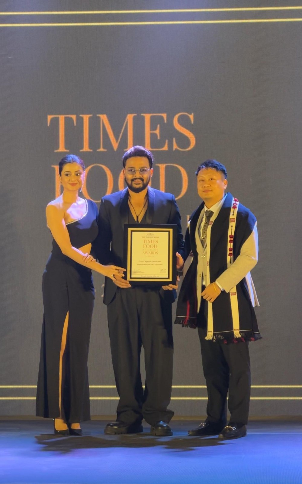 Café Captain Americano owner Mikato Shohe (right) receives the Noteworthy Newcomer Café-Casual Dining award at the Times Food & Nightlife Awards 2024-2025 in Kolkata.